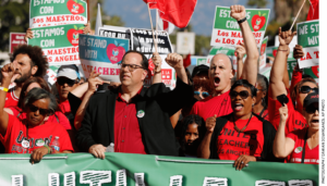 The president of United Teachers Los Angeles, Alex Caputo-Pearl, center, joins unionized teachers at a rally in the city in 2018.