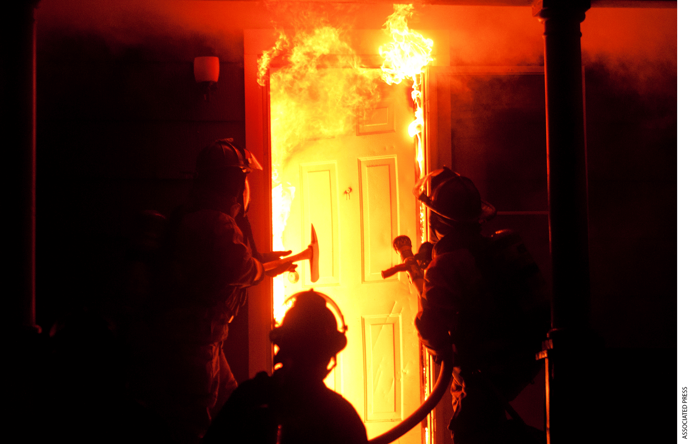 In a Monday, Sept. 17, 2012 photo, Saginaw fire fighters enter a house on the corner of Jackson and Fayette in Saginaw about 11:30 pm.