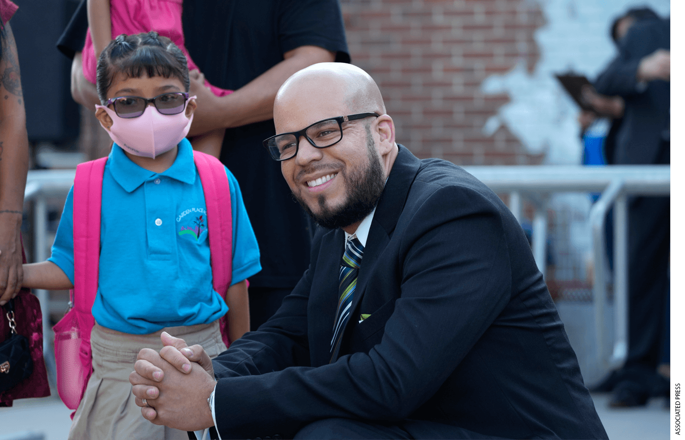 Alex Marrero, front, superintendent of Denver Public Schools, greets students for the first day of in-class learning since the start of the pandemic at Garden Place Elementary School Monday, Aug. 23, 2021