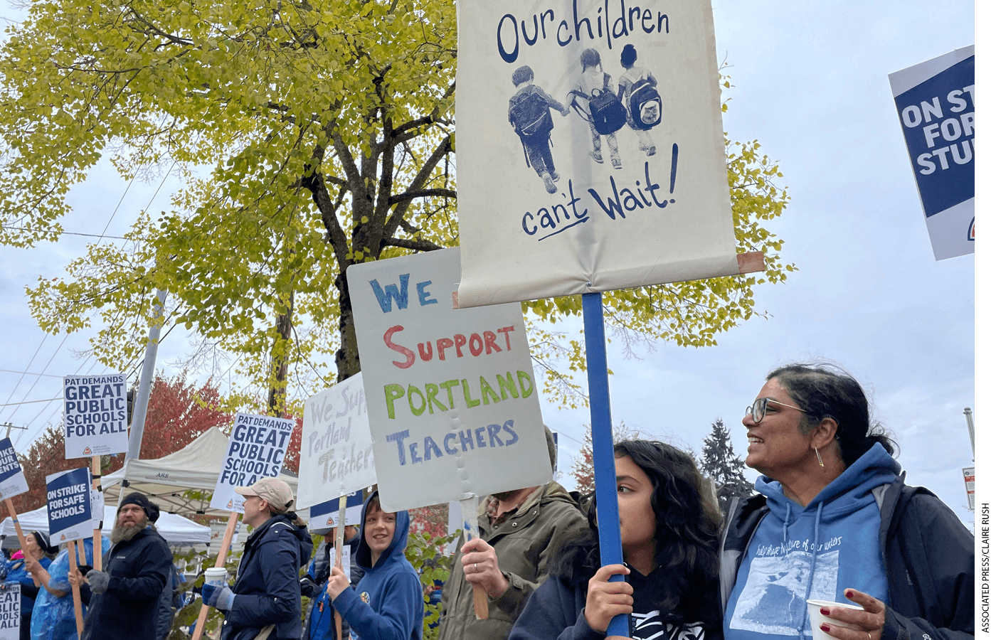 Teachers and their supporters hold signs, chant, and rally the crowd on the first day of a teacher's strike in Portland, Ore., Nov. 1, 2023.