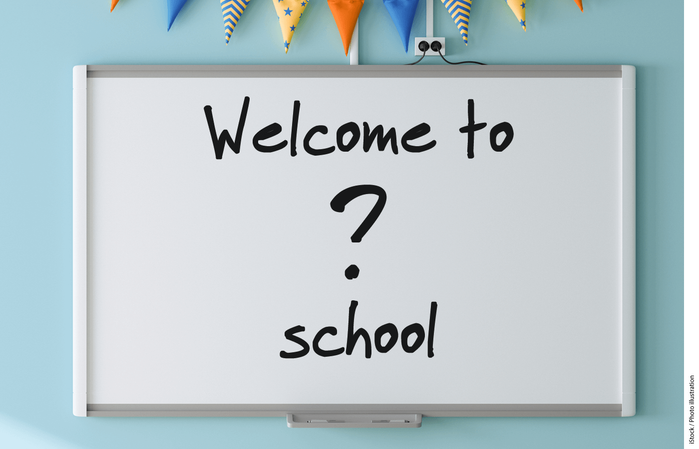 A whiteboard with "Welcome to ? school" written in marker on it