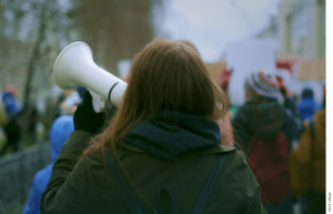 Photo of a young woman demonstrating at a protest