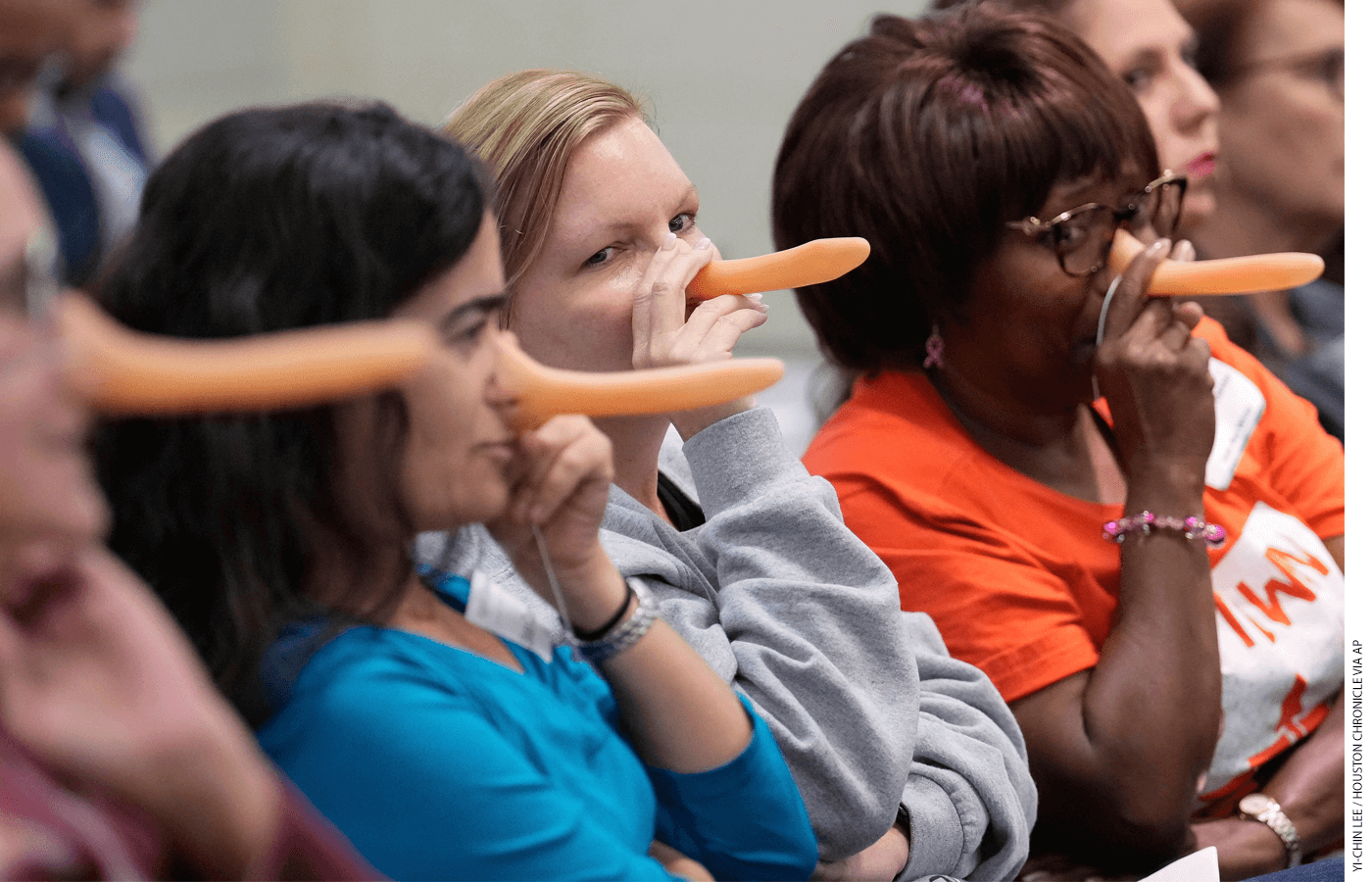 At the district’s board meeting in October 2023, attendees don fake Pinocchio noses in response to Miles’s comments about principal evaluations.