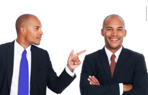 A man in a blue tie points to a man in a red tie