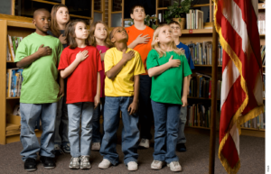 Students stand for the pledge of allegiance