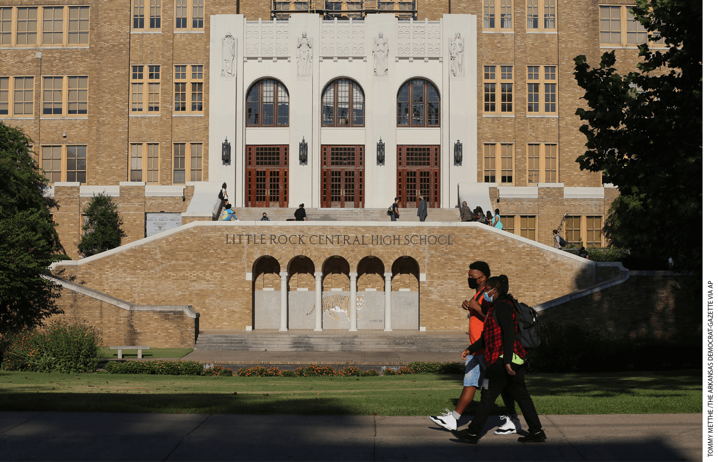 Students walk past Little Rock Central High School