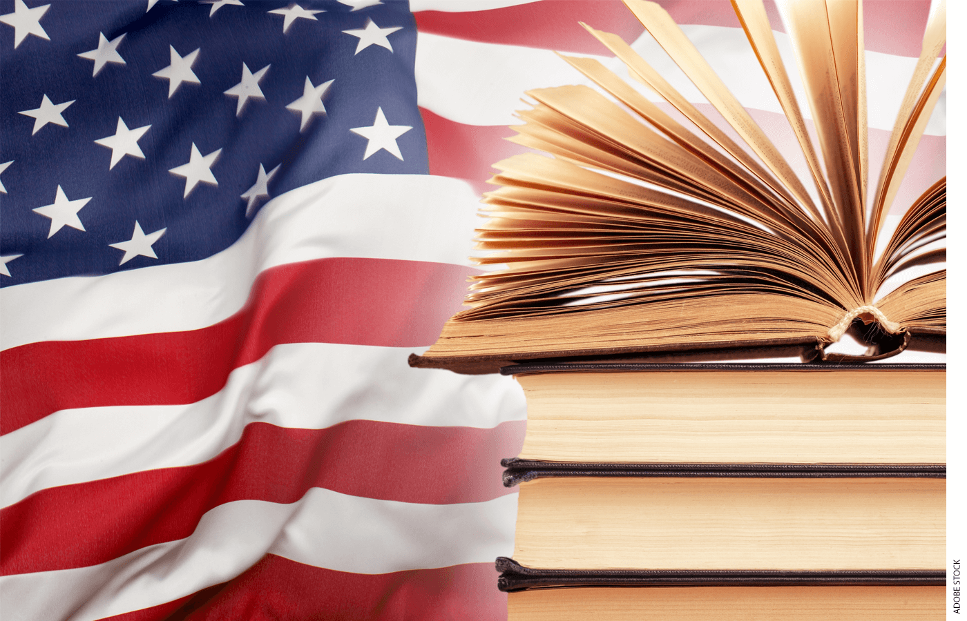 Stack of textbooks with American flag in the background